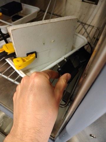 Measuring drywall moisture content during validation.